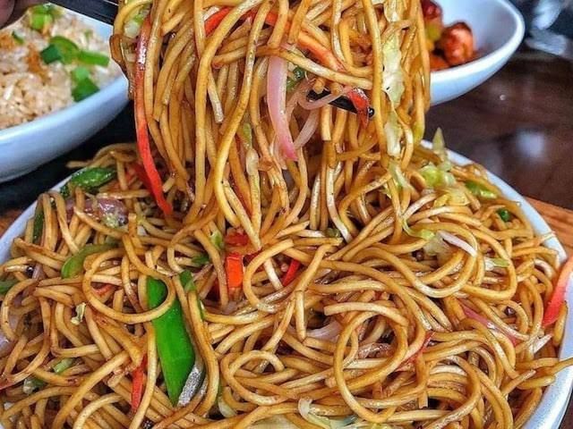 May be an image of pasta, chow mein, ramen, fried rice and noodles